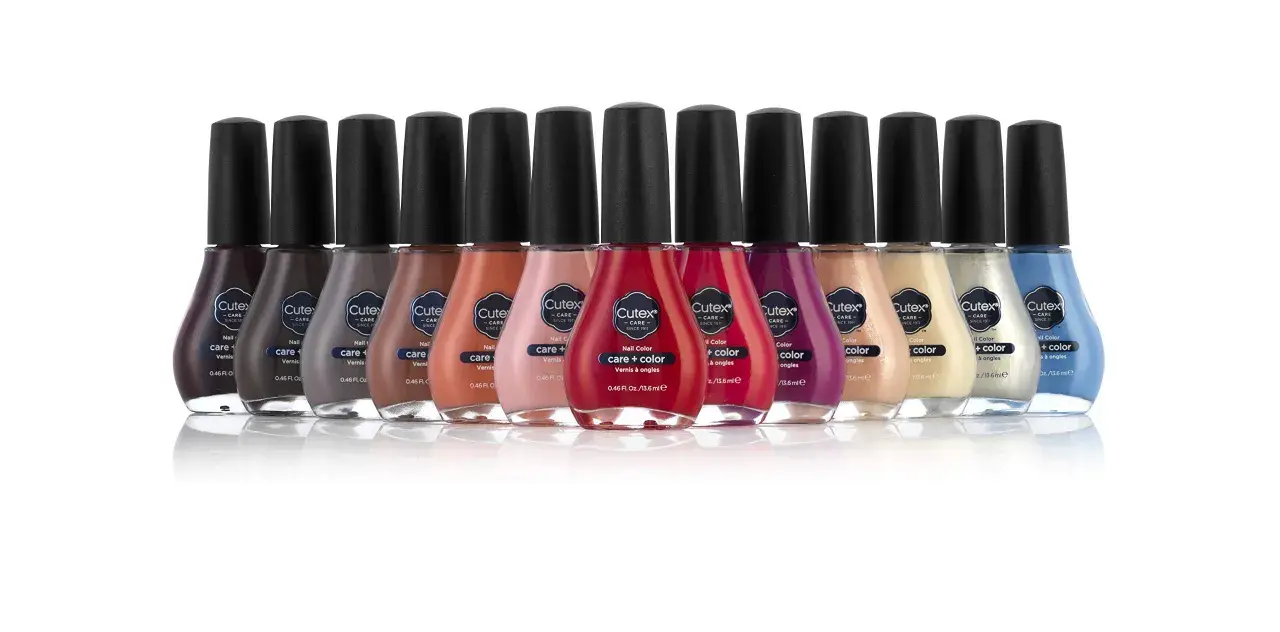 En rad med flaskor med Cutex nagellack i olika färger, från mörkt lila till ljusblått.